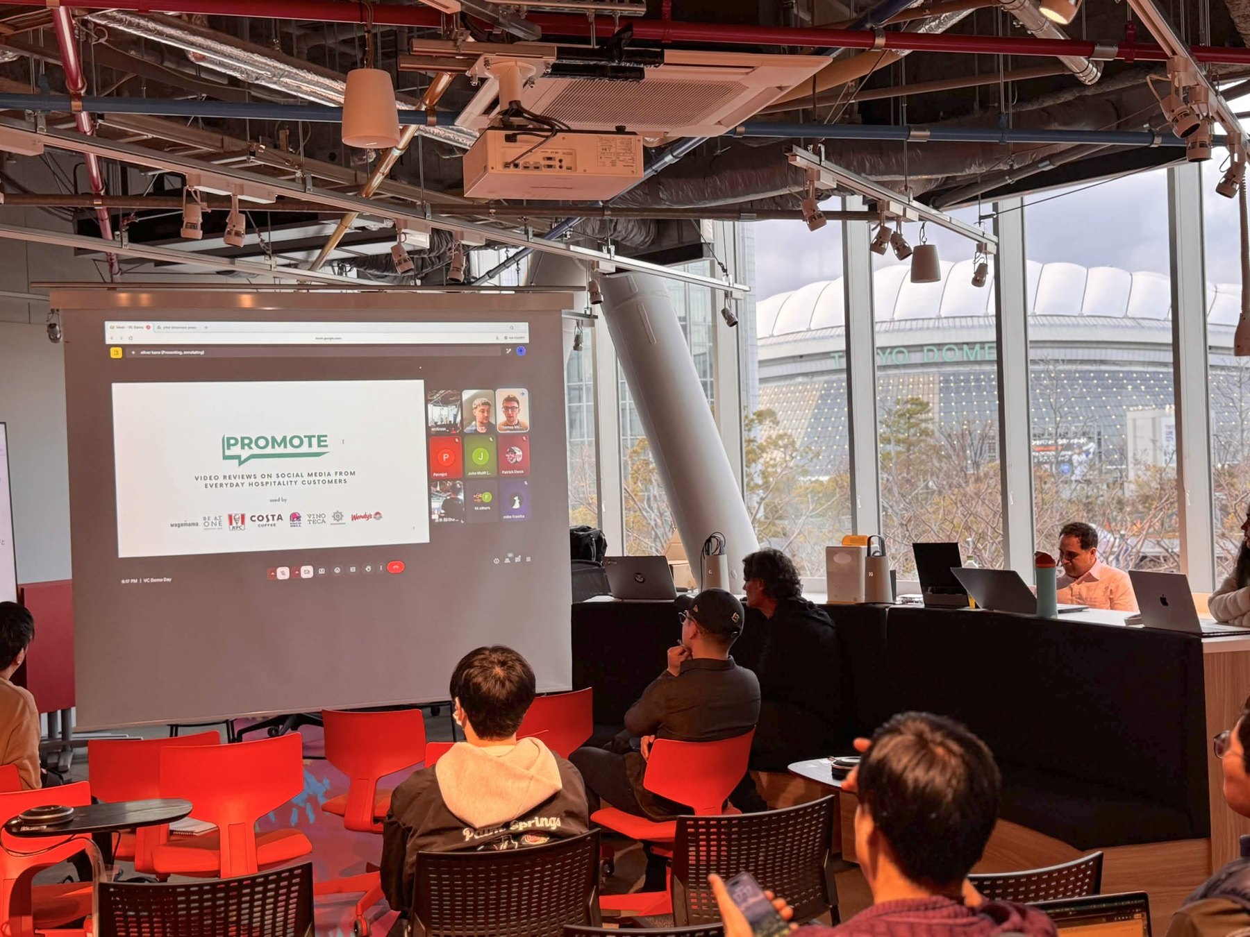 OpenDome founders in a presentation session with a pink screen