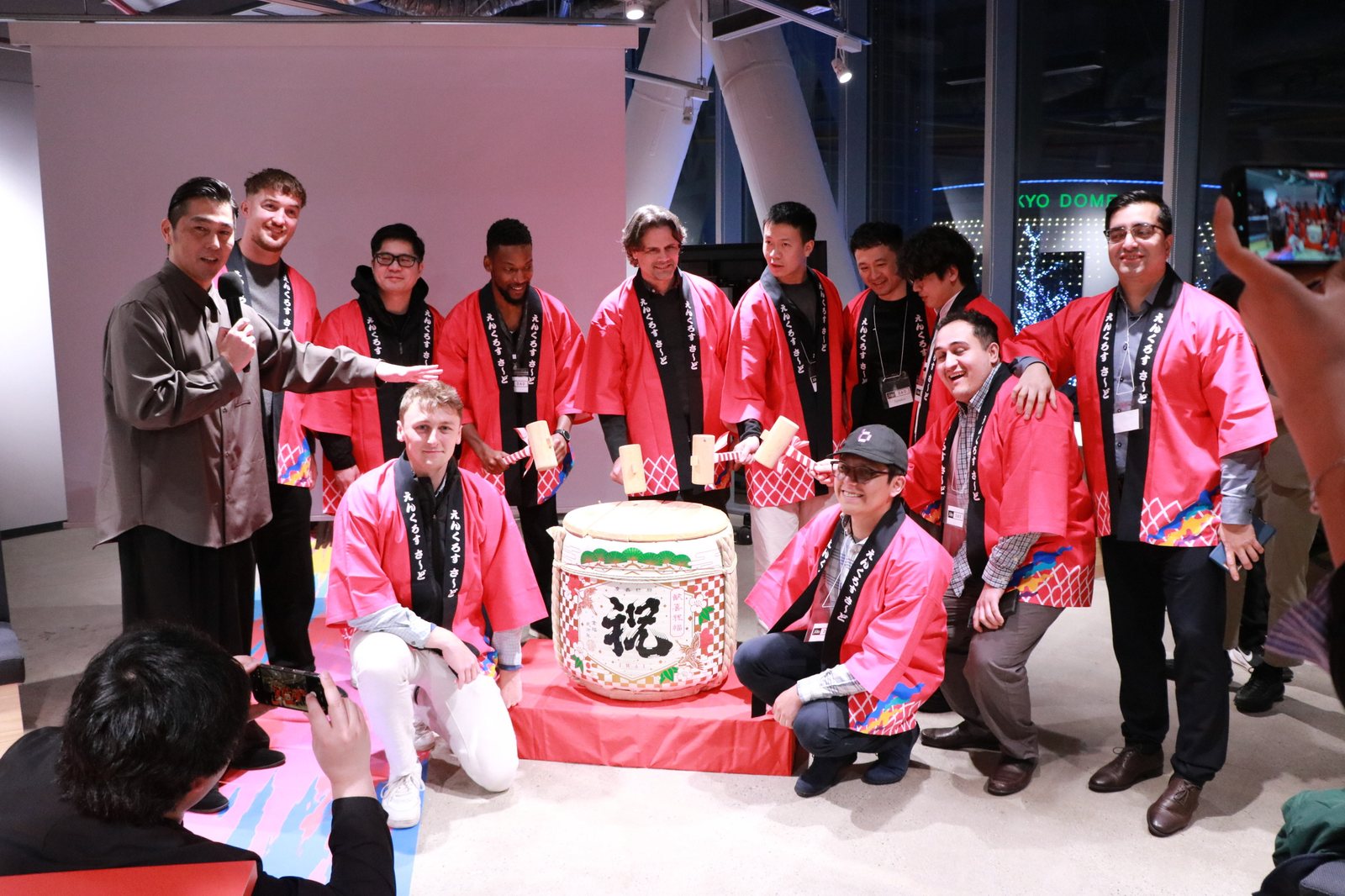 OpenDome founders gathered around a sake barrel ceremony in happi coats